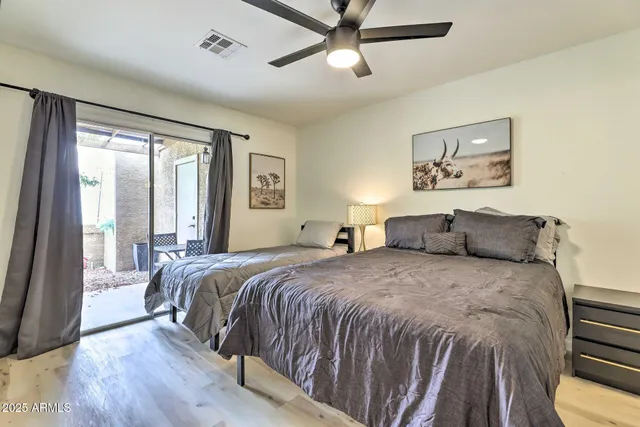 a bedroom with a bed and a large window