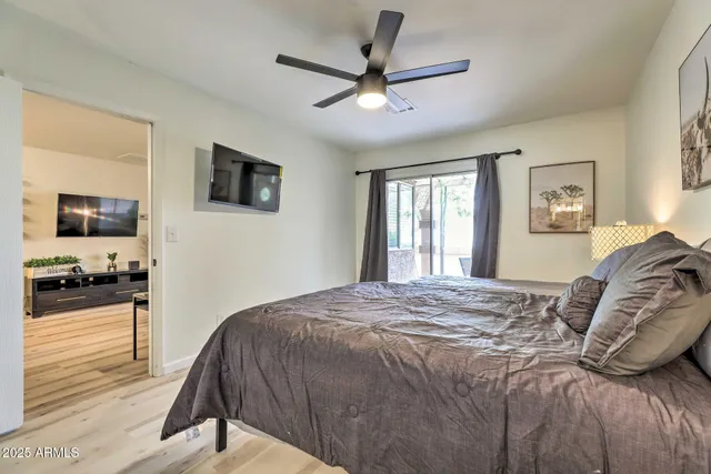 a bedroom with a bed and a flat screen tv