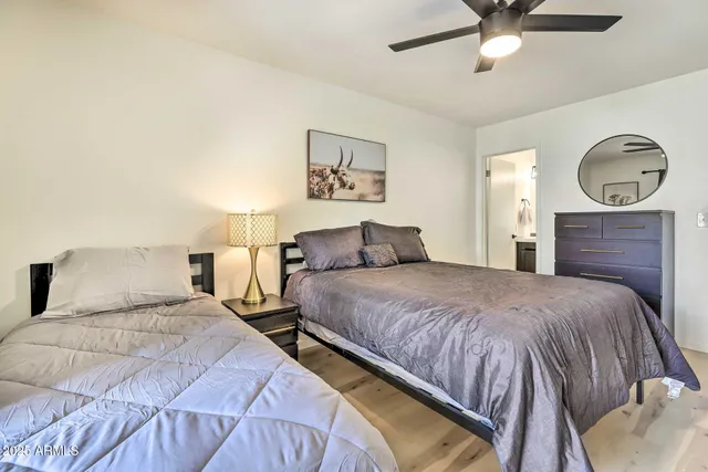 a bedroom with a bed and a chandelier