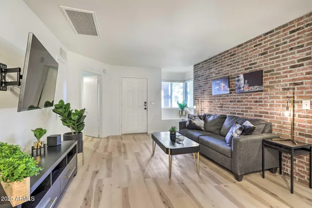 a living room with furniture and wooden floor