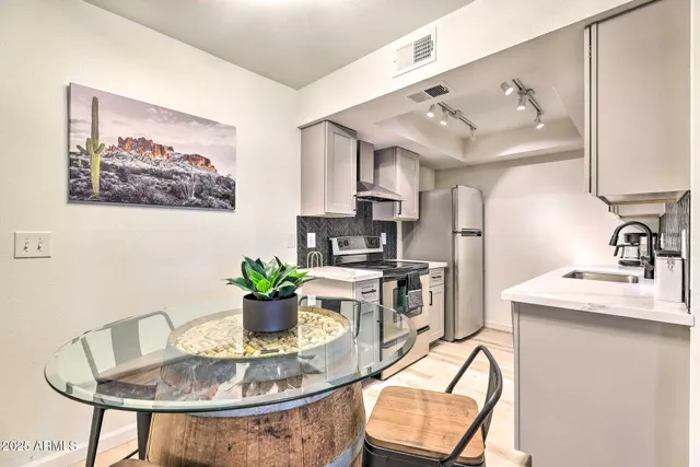 a kitchen with a table and chairs