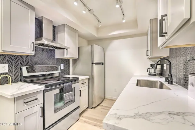 a kitchen with a stove sink and refrigerator