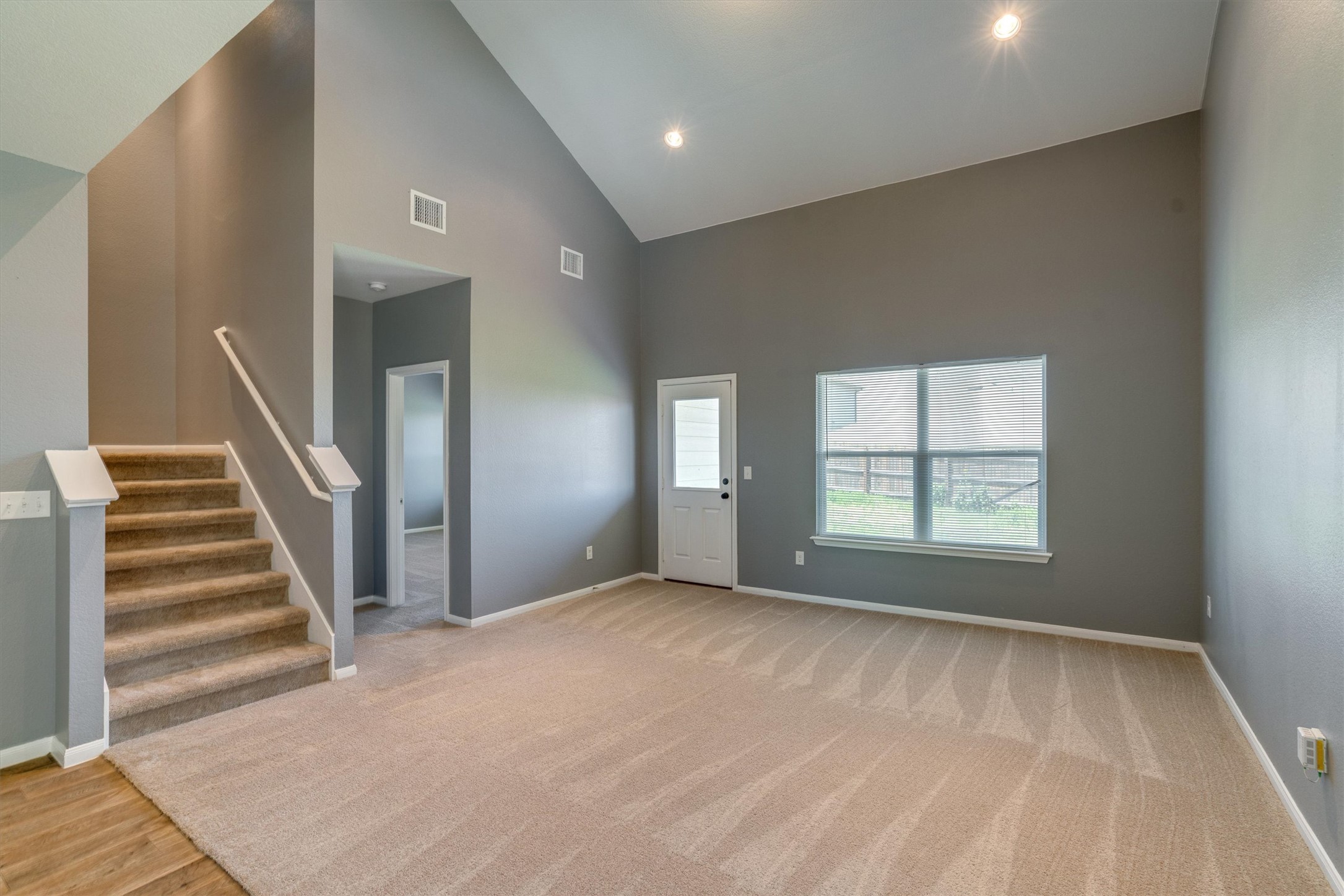 15128 Shell Bark Cove Austin, TX 78724 - Photo 5 of 25 A spacious living area with vaulted ceilings offers a bright and open atmosphere.