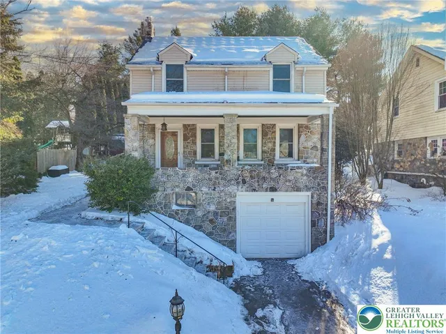a view of a hallway with wooden floor and a chandelier