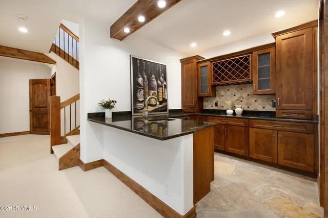 a kitchen with stainless steel appliances granite countertop a sink a stove and a refrigerator