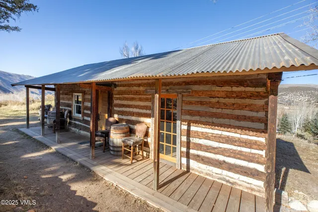 a view of a patio with table and chairs under an umbrella with wooden floor