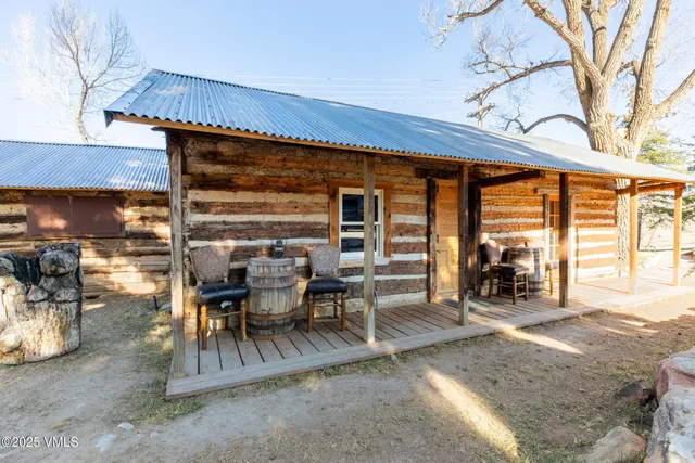 a view of a patio with table and chairs and floor to ceiling window