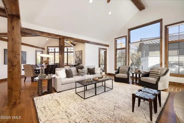 a living room with furniture and large windows