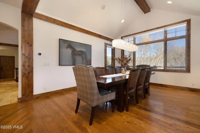 a view of a a dining room with furniture window and wooden floor