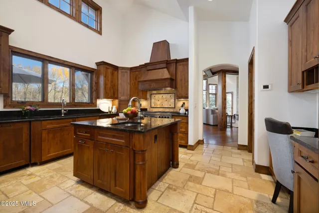 a kitchen with stainless steel appliances granite countertop a sink and cabinets