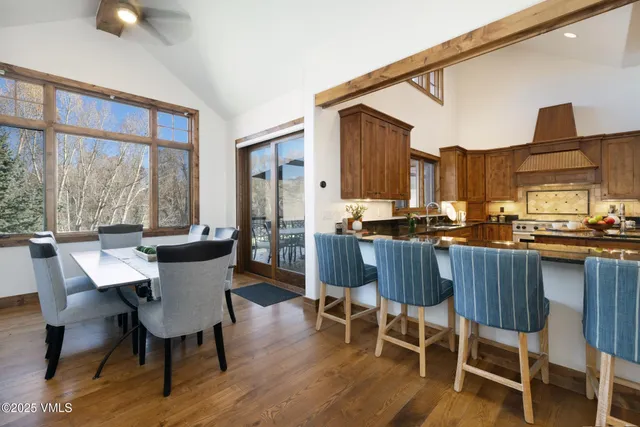 a dining room with furniture a window and wooden floor