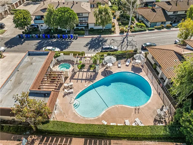 an aerial view of a house with outdoor space and pool