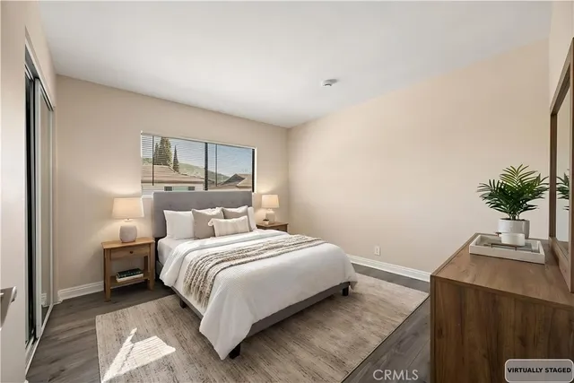 a bedroom with a bed and a potted plant