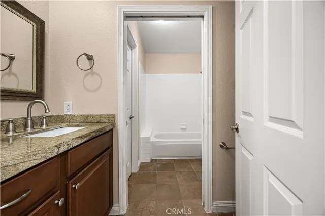 a white toilet sitting next to a bath tub