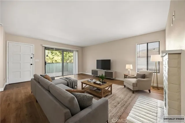a living room with furniture window and a flat screen tv