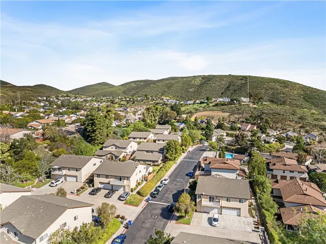 an aerial view of residential houses with outdoor space and swimming pool