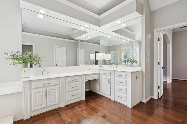 a spacious bathroom with a double vanity sink and a mirror