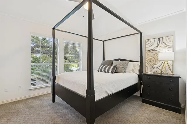 a bed sitting in a bedroom next to a window