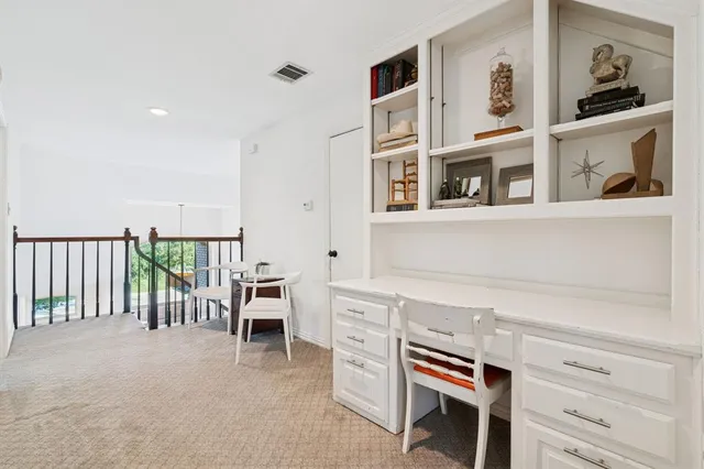 a hallway with a white cabinets and wooden floor