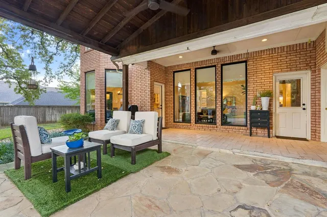 a building outdoor space with patio furniture and potted plants