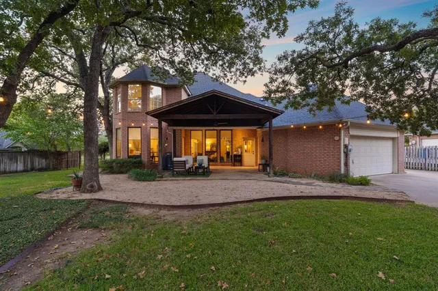 a view of a house with a yard and tree s