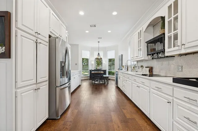 a kitchen with stainless steel appliances a refrigerator sink and cabinets