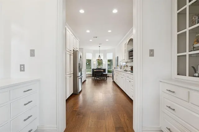 a view of a kitchen with furniture and wooden floor