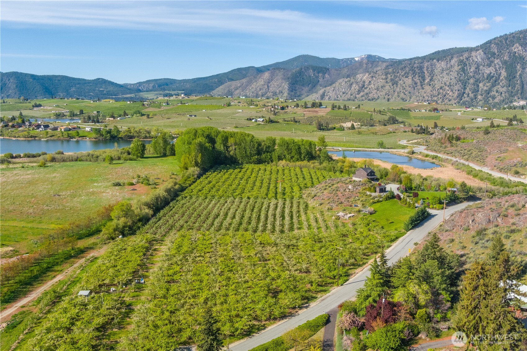 0 Lower Joe Creek Road Manson, WA 98831 - Photo 9 of 10 a view of a lush green hillside and houses
