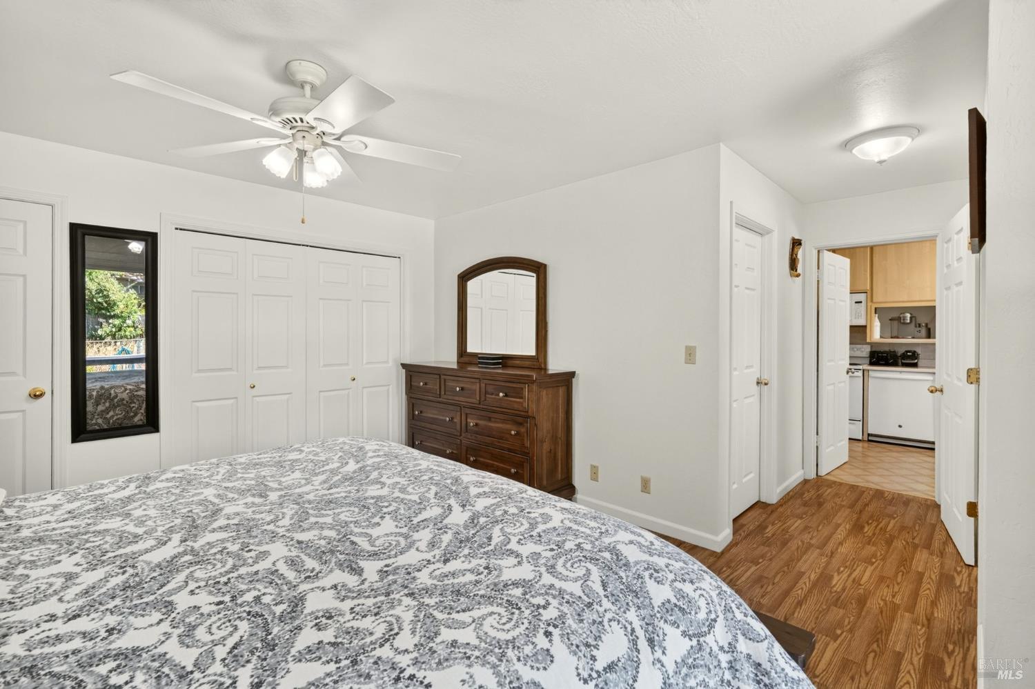 92 Oak Knoll Road Ukiah, CA 95482 - Photo 16 of 35 a bedroom with a large bed and a chandelier