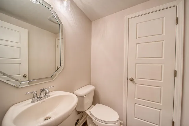 a view of an empty room with closet and a window