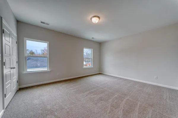 a view of an empty room and a window