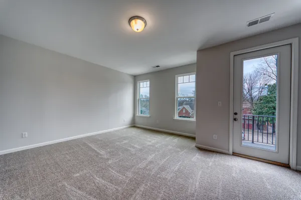 an empty room with windows and entrance