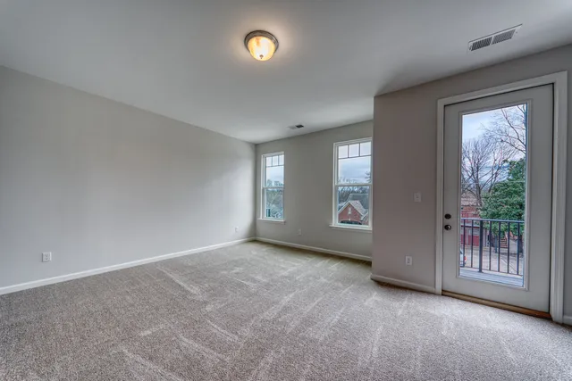 an empty room with windows and entrance