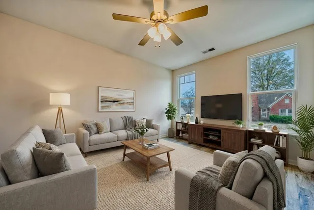 a living room with furniture and a flat screen tv