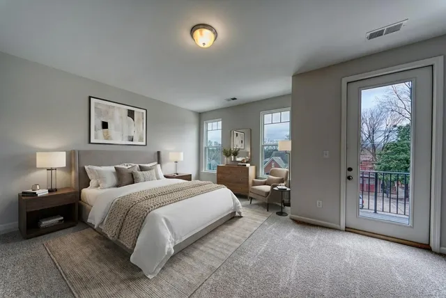 a bedroom with a bed and a large window