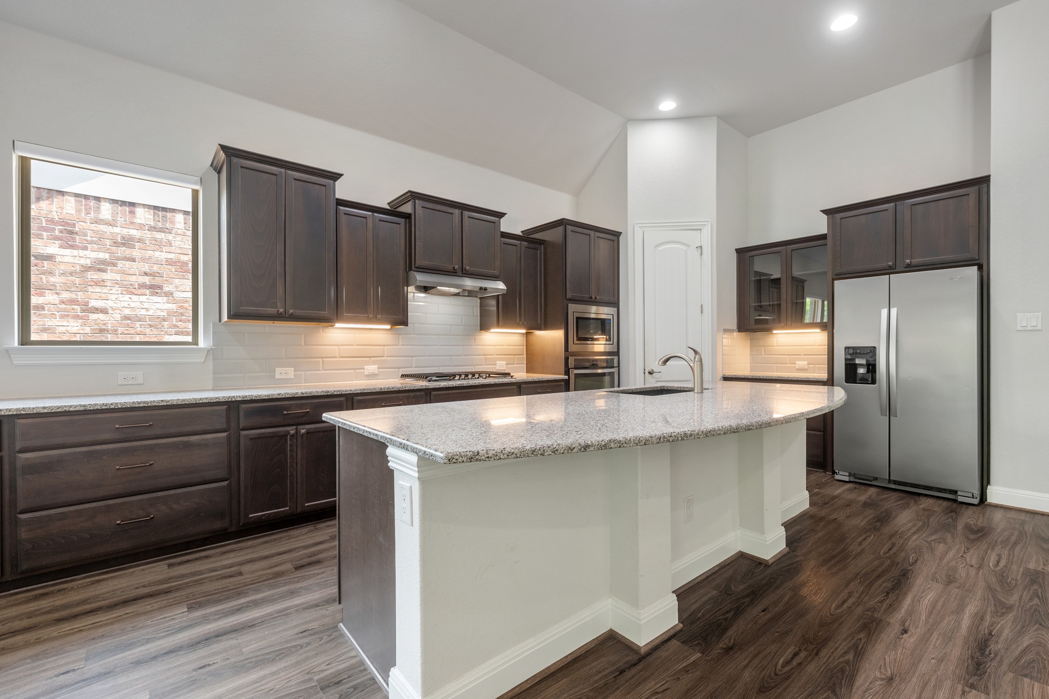 2709 Steece Way Leander, TX 78641 - Photo 13 of 39 a kitchen with stainless steel appliances granite countertop a sink stove and refrigerator