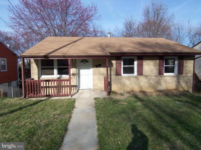 a front view of a house with a garden and yard