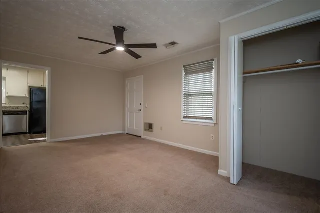 a view of a livingroom with a ceiling fan and window