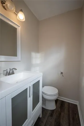 a wooden house with large trees and outdoor space