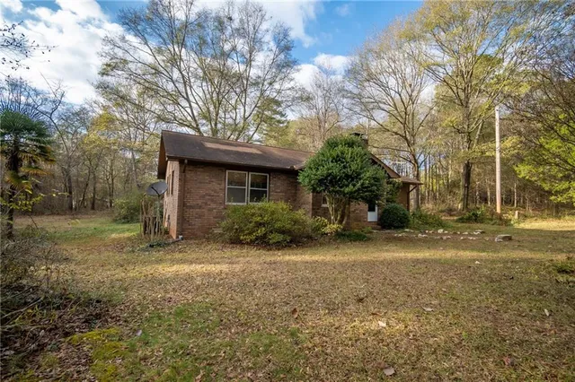 a view of a house with yard and a tree