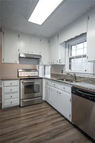 an empty room with closet and windows
