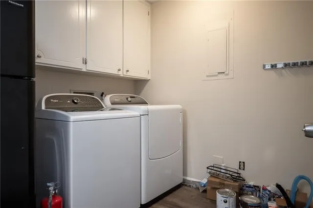 a view of backyard with wooden fence and large trees