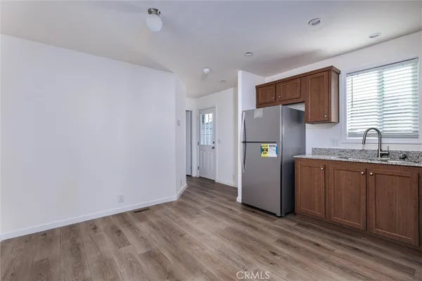 a kitchen with stainless steel appliances granite countertop a refrigerator and a sink