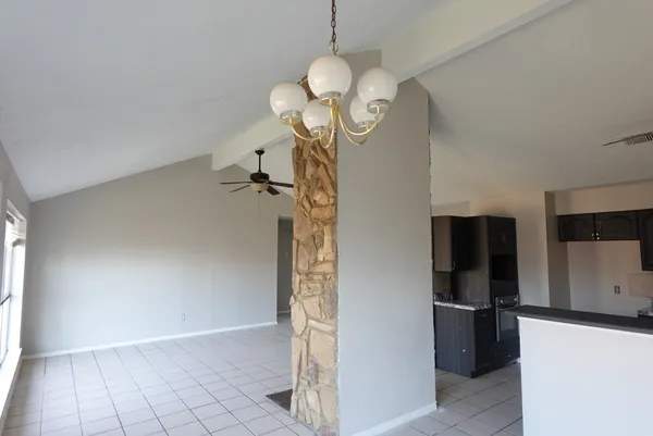 a view of a kitchen with a refrigerator and a chandelier