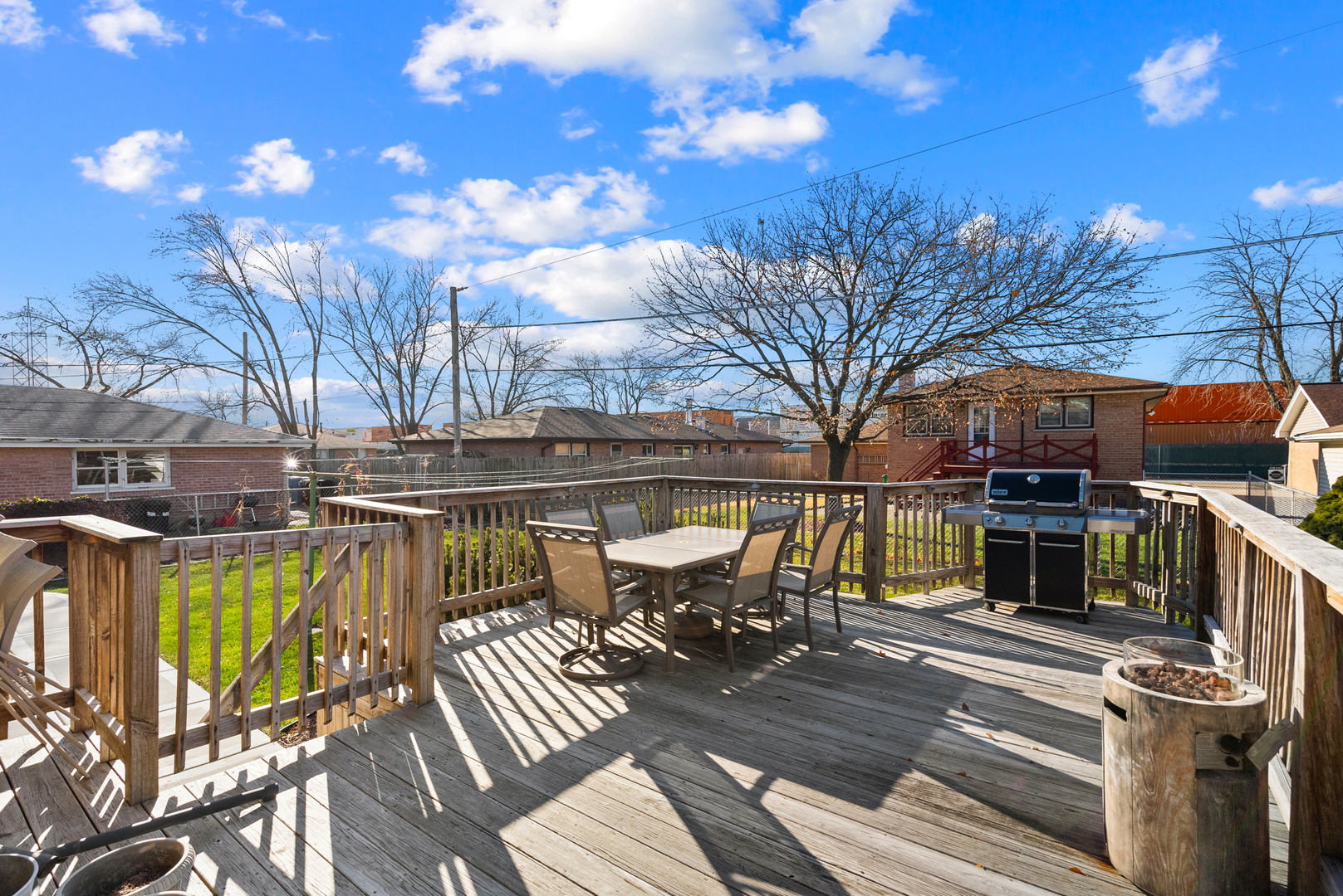 8232 Ferdinand Avenue Bridgeview, IL 60455 - Photo 16 of 35 a view of a patio with table and chairs with wooden floor and fence