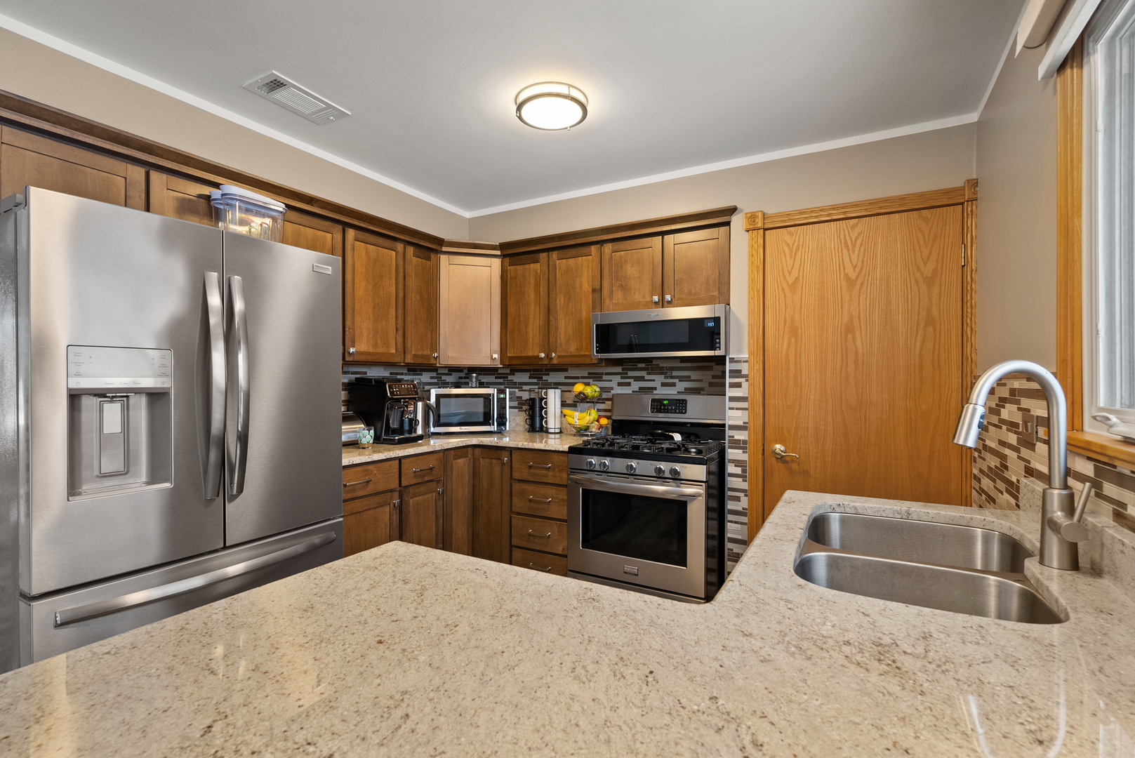 8232 Ferdinand Avenue Bridgeview, IL 60455 - Photo 4 of 35 a kitchen with granite countertop a refrigerator stove and sink