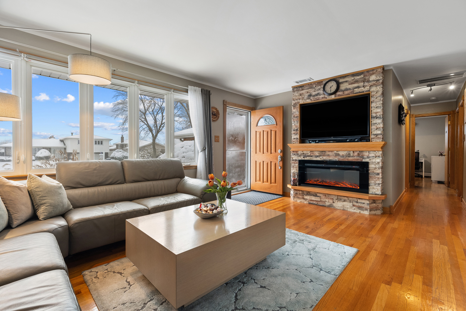 8232 Ferdinand Avenue Bridgeview, IL 60455 - Photo 6 of 35 a living room with furniture a flat screen tv and a fireplace