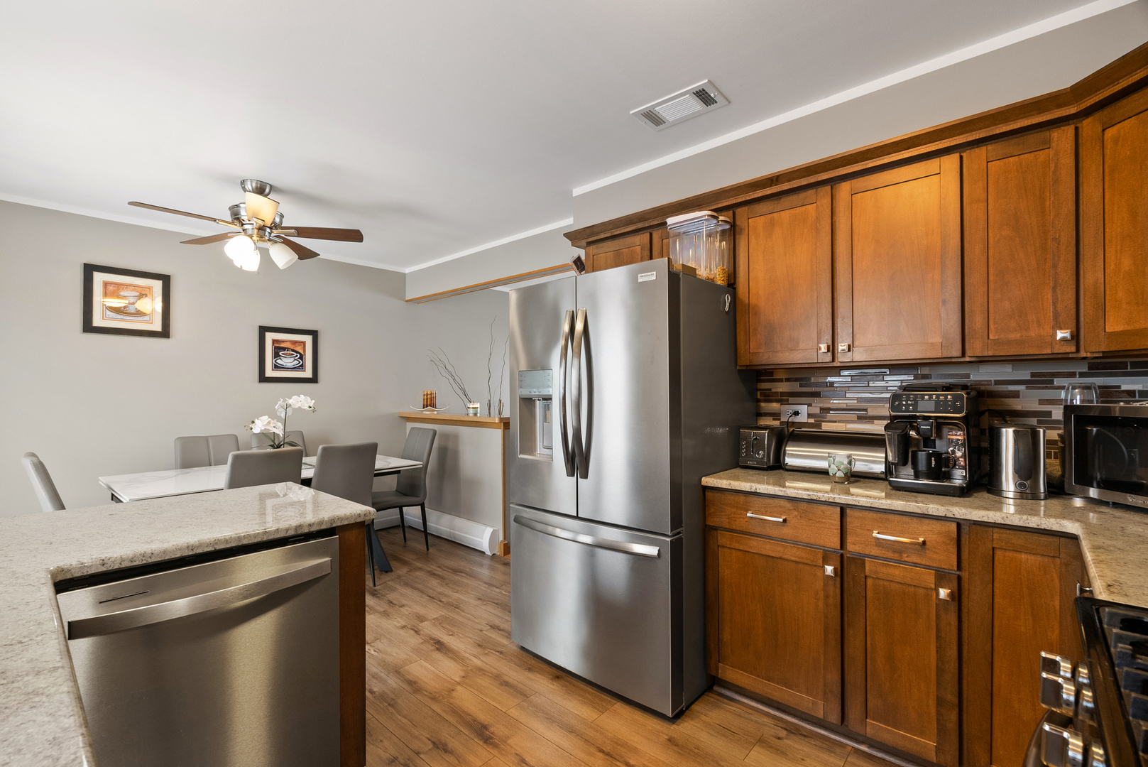 8232 Ferdinand Avenue Bridgeview, IL 60455 - Photo 8 of 35 a kitchen with stainless steel appliances granite countertop a refrigerator a stove a sink dishwasher and a microwave oven with cabinets
