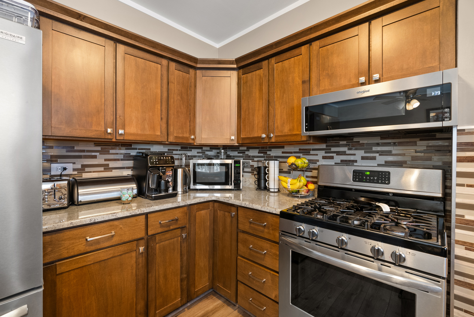 8232 Ferdinand Avenue Bridgeview, IL 60455 - Photo 9 of 35 a kitchen with stainless steel appliances granite countertop a stove a sink and a microwave
