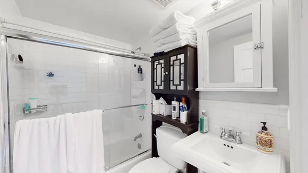 a bathroom with a sink toilet and shower